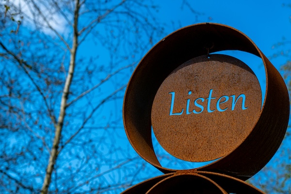 Listen carved into metal.